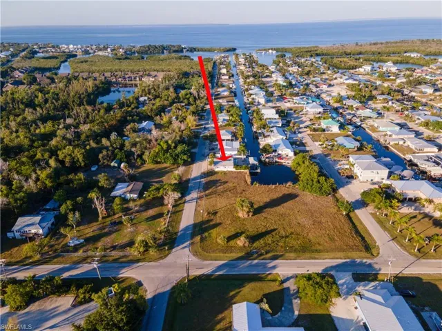 Aerial overview of property's location with a nearby body of water and nearby suburban area