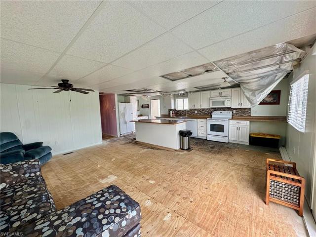 Living Room and Kitchen showing roof damage.