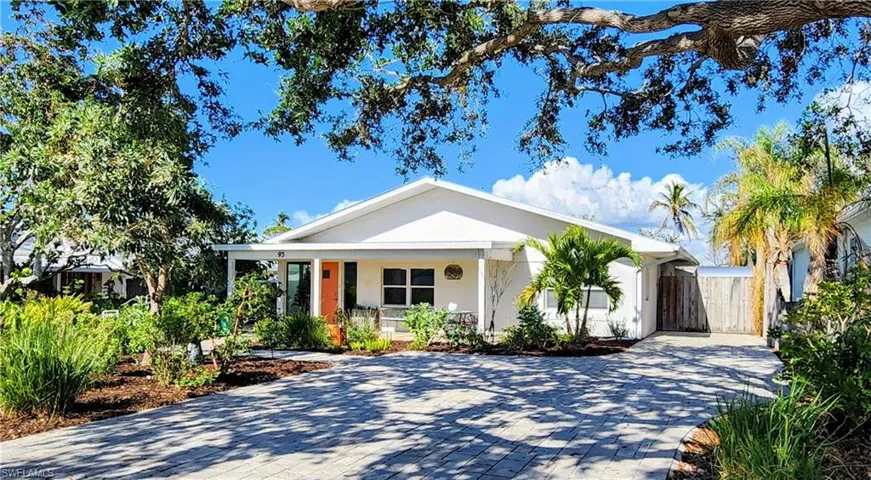 View of front of home with driveway and gate to RV/Boat storage area