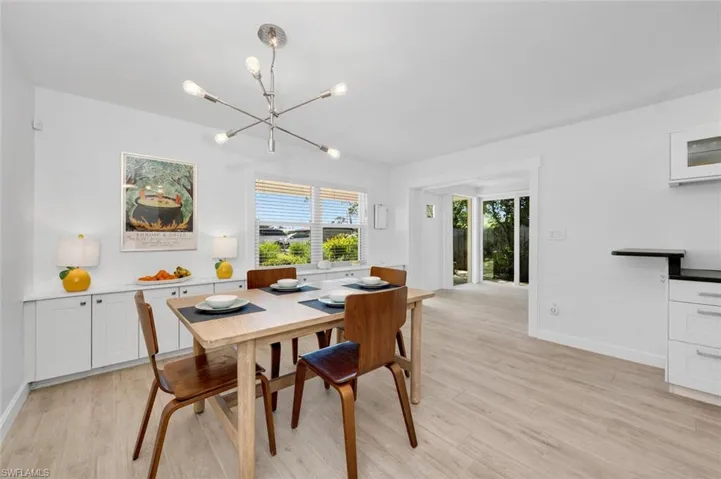 Dining room featuring an inviting chandelier and light wood-style tile flooring