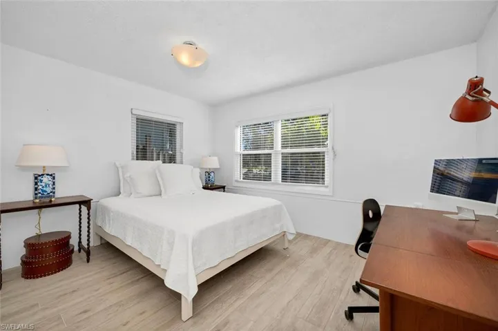 Bedroom with light wood-style tile floors