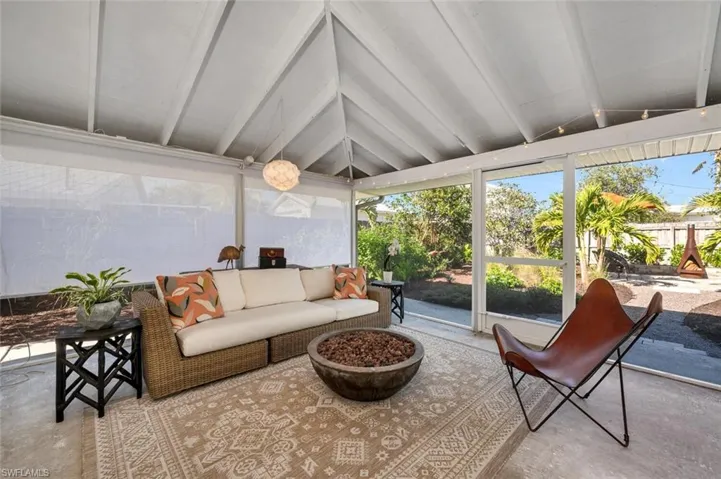 Sunroom / solarium featuring lofted ceiling with beams