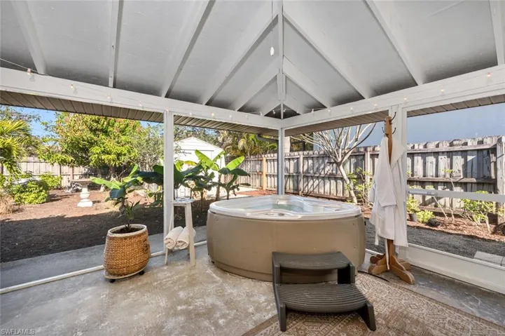 Sunroom with a jacuzzi and vaulted ceiling