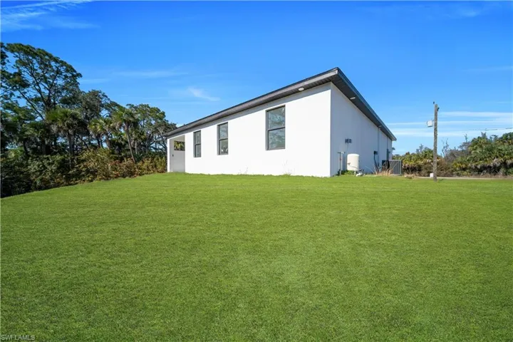 View of property exterior featuring a yard