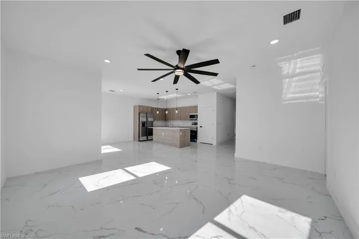 Unfurnished living room with a ceiling fan and recessed lighting
