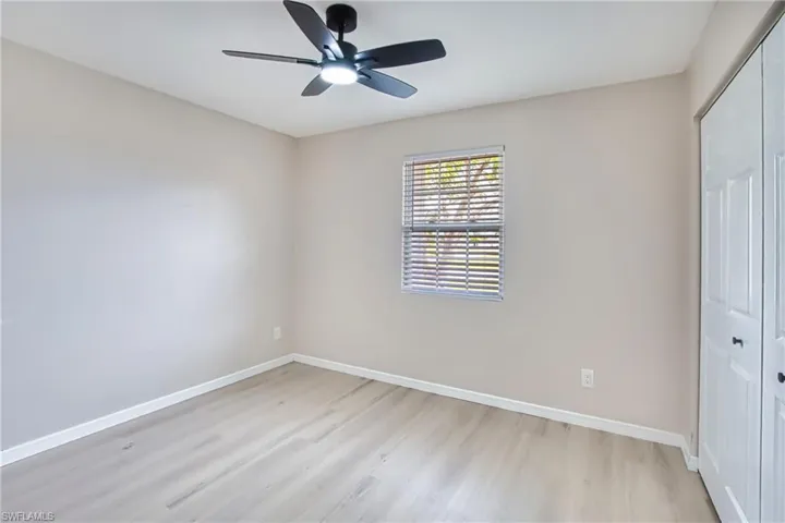 Unfurnished bedroom with a closet, light wood finished floors, and ceiling fan