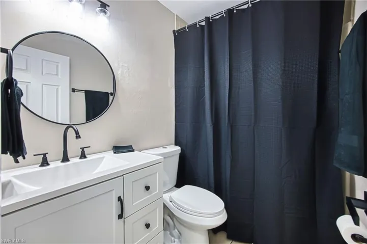 Full bath featuring vanity and a shower with shower curtain