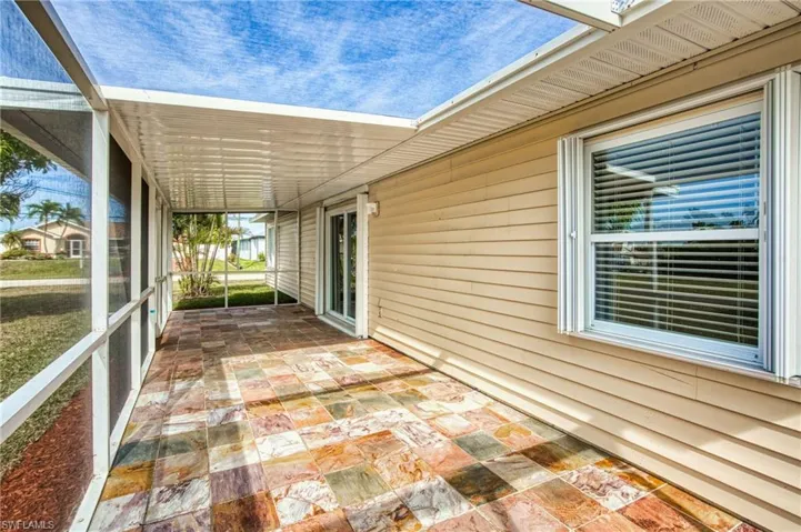 View of patio featuring a sunroom