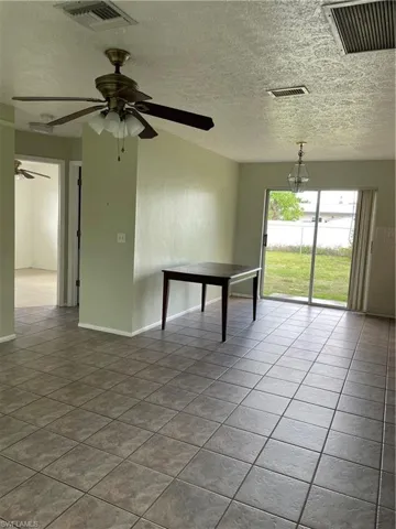 Tiled spare room with ceiling fan, baseboards, and visible vents