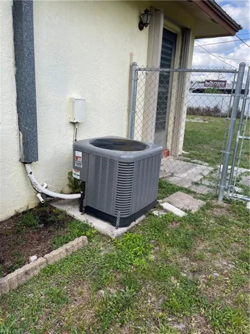 Details featuring central AC, fence, and stucco siding