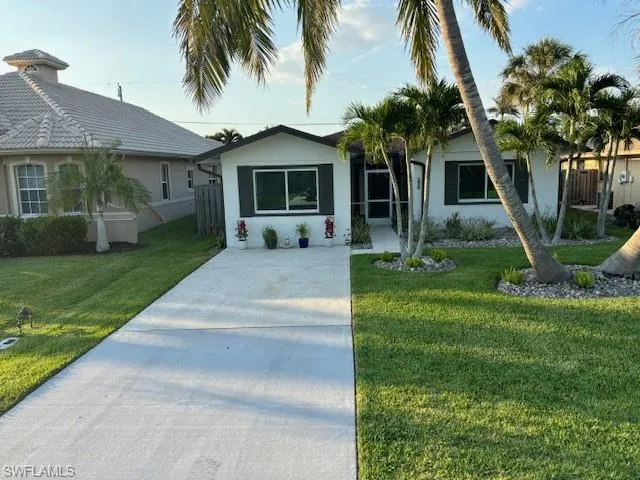 Single story home with a front lawn