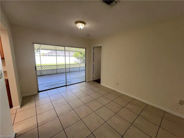 Dining room with light tile patterned floors and access to exterior