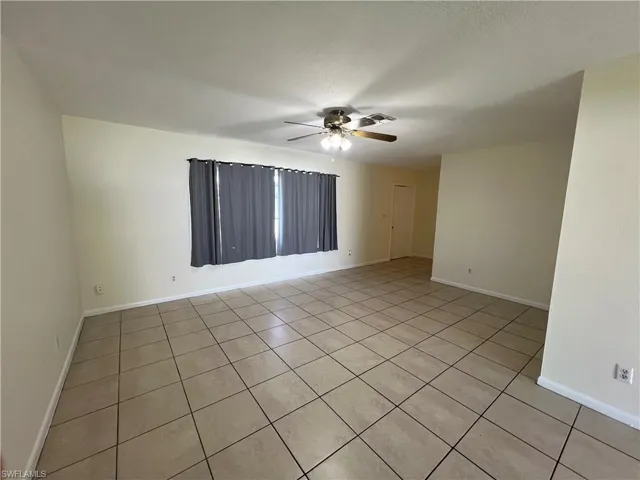 Tiled Living room featuring ceiling fan