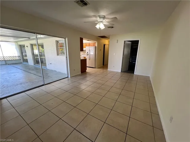 Family room featuring ceiling fan and light tile patterned flooring