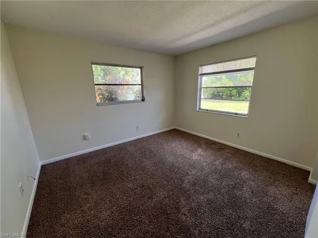 Guest bedroom  featuring a textured ceiling