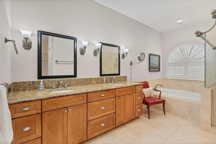 Bathroom with tiled tub and vanity