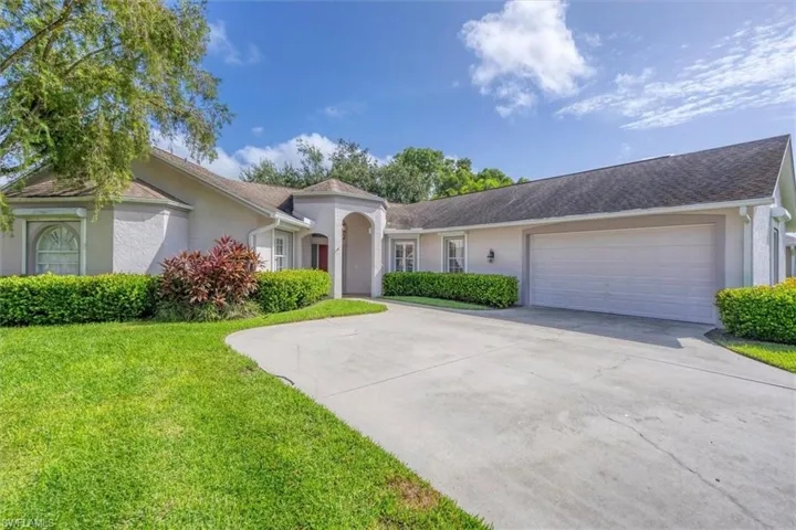Single story home featuring a front lawn and a garage