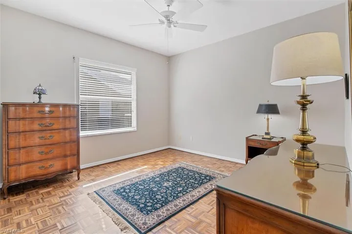 Office area featuring parquet floors and ceiling fan