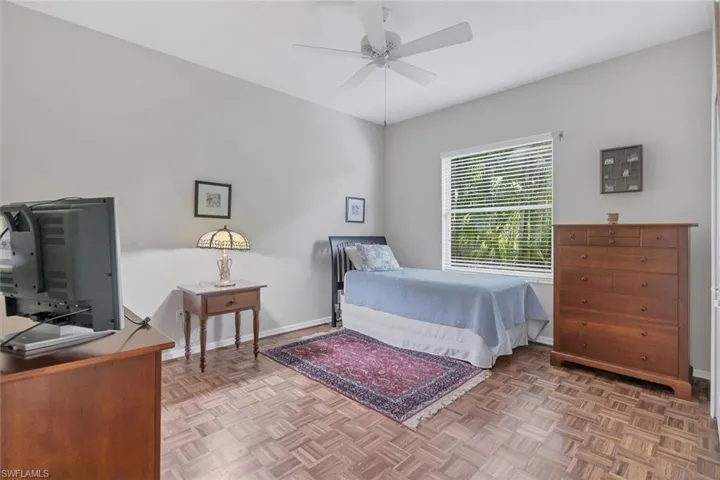 Bedroom featuring ceiling fan and parquet flooring