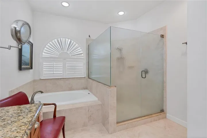 Bathroom featuring independent shower and bath and tile patterned floors