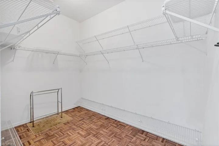 Spacious closet featuring parquet floors