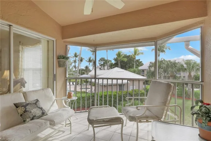 Sunroom with tile patterned flooring and a textured wall