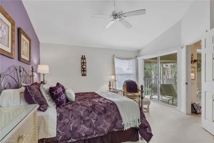 Bedroom featuring lofted ceiling, access to outside, carpet flooring, and a ceiling fan