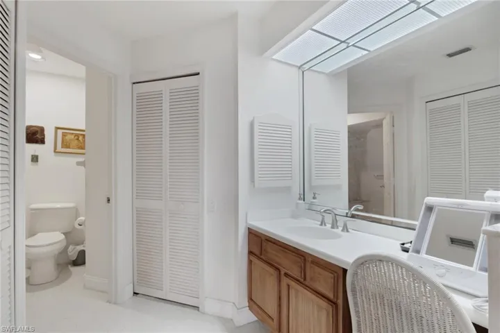 Bathroom with a closet and vanity