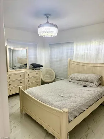 Bedroom with light marble finish flooring