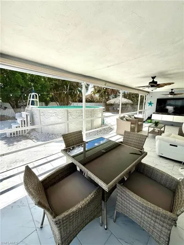 Fenced backyard with outdoor seating, a ceiling fan, a patio area, and an outdoor pool