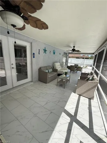 View of patio / terrace featuring a ceiling fan, a sunroom, and outdoor lounge area