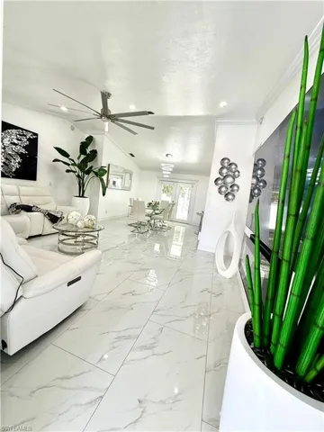 Living area featuring recessed lighting and a ceiling fan