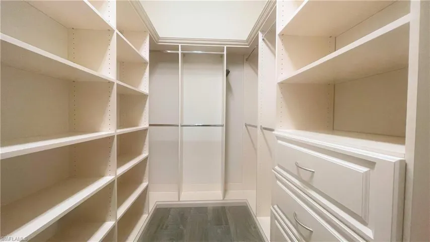 Spacious 2 of 2 Primary Bedroom Walk-In Closets with Custom Shelving