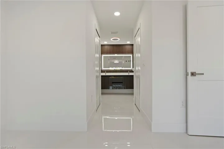 Hall with tile patterned flooring and recessed lighting