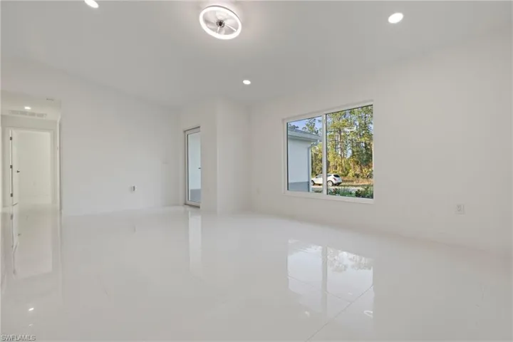 Tiled empty room with recessed lighting