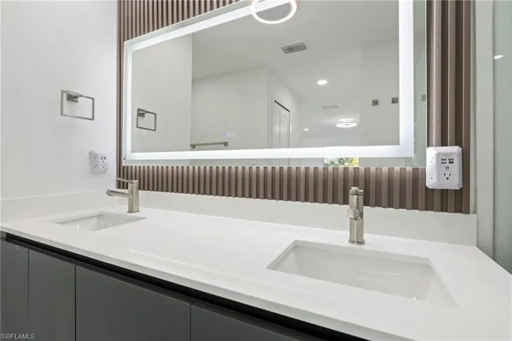 Full bath featuring double vanity and recessed lighting