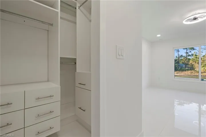 Walk in closet featuring light tile patterned floors