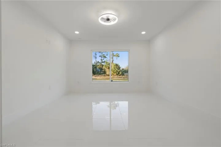 Unfurnished room with tile patterned flooring and recessed lighting