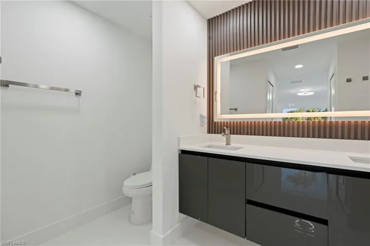 Bathroom featuring tile patterned floors, vanity, and toilet