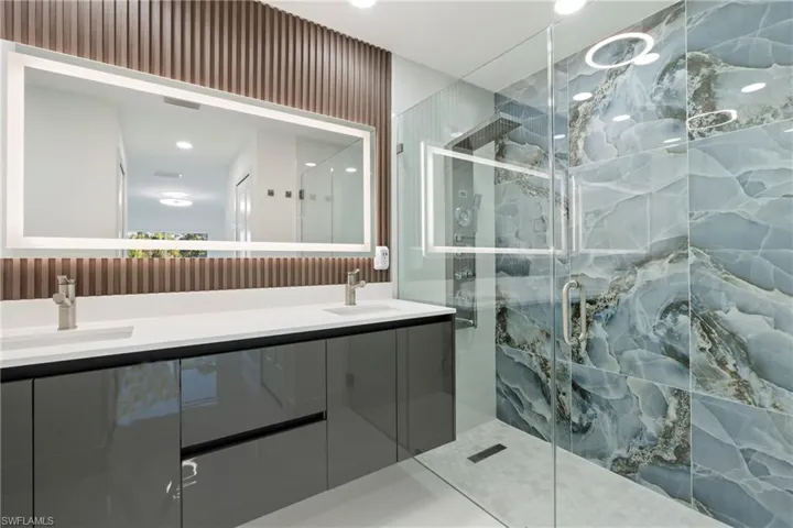 Bathroom with vanity and a shower with shower door