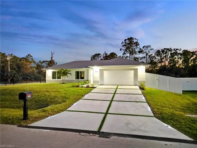 Ranch-style house with a lawn and a garage