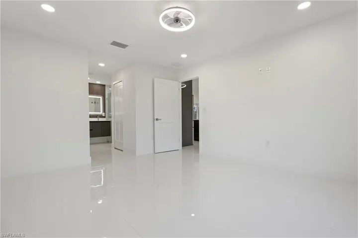 Unfurnished room with recessed lighting and light tile patterned flooring