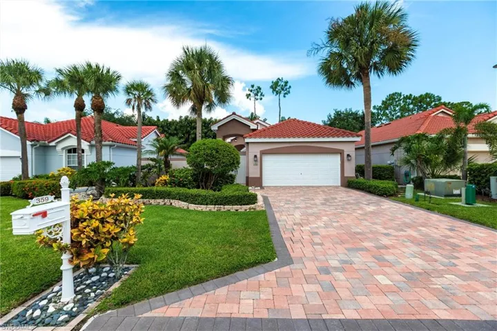 Mediterranean / spanish house with a garage and a front lawn