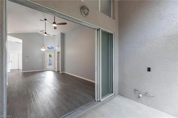 Doorway to property with ceiling fan