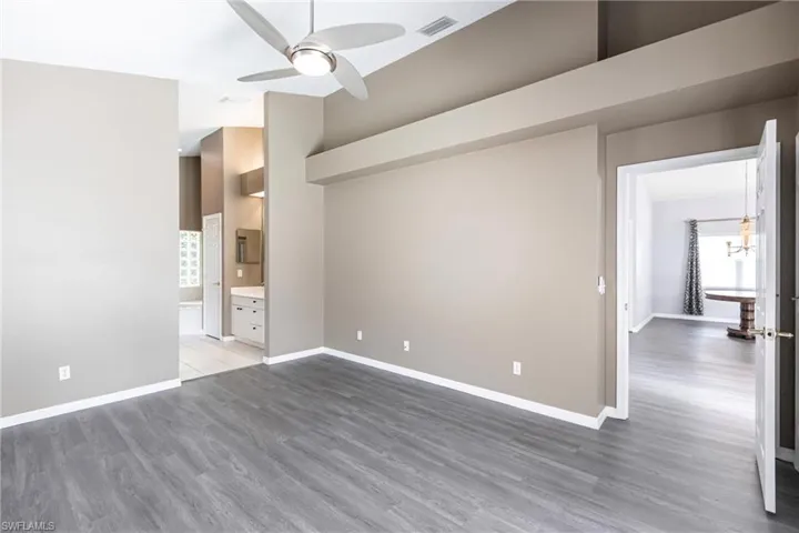 Unfurnished room featuring ceiling fan and hardwood / wood-style floors