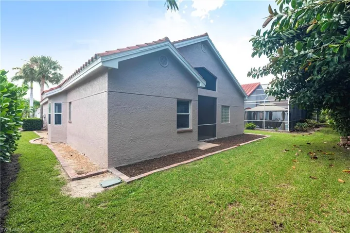 View of home's exterior with a yard