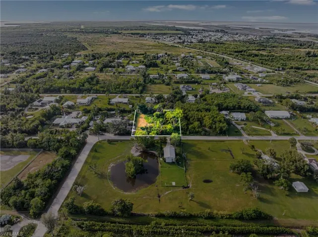 Aerial overview of property's location with a tree filled landscape and property boundaries highlighted