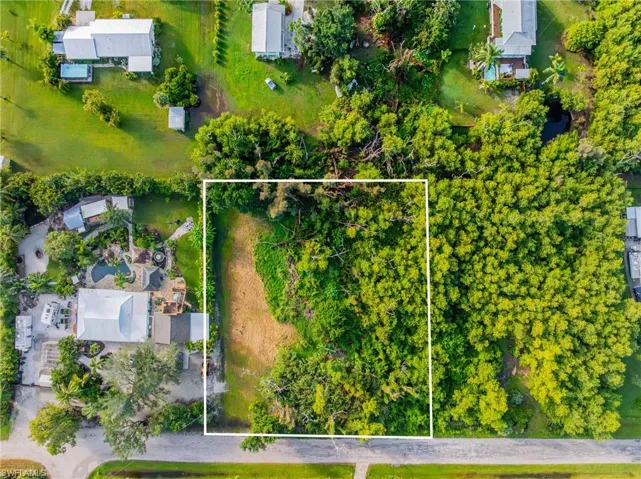 Aerial view of property and surrounding area featuring property parcel outlined