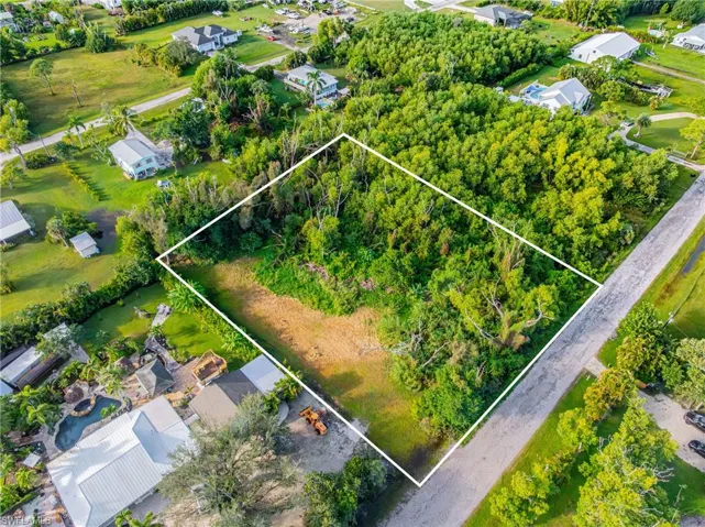 Aerial view of residential area with property parcel outlined