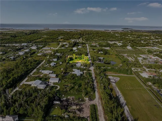 View of property location featuring a large body of water and nearby suburban area